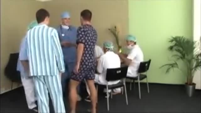 Medical exam with five doctors and two patients