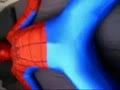 Spiderman tied down by black spiderman and toyed with