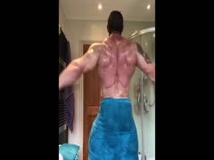 Muscle stud flexing in towel