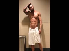 Muscle stud flexing in towel