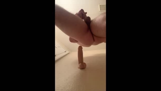 cute hunk taking a dildo