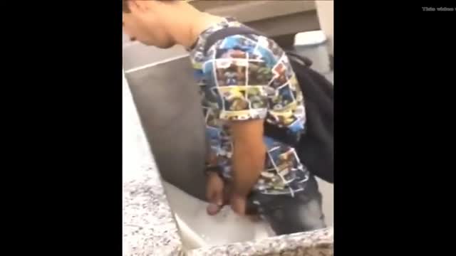 dude wanking uncut cock at urinal in public toilet