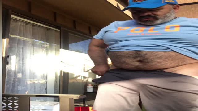 Older Latino Bear Shows Off Outside